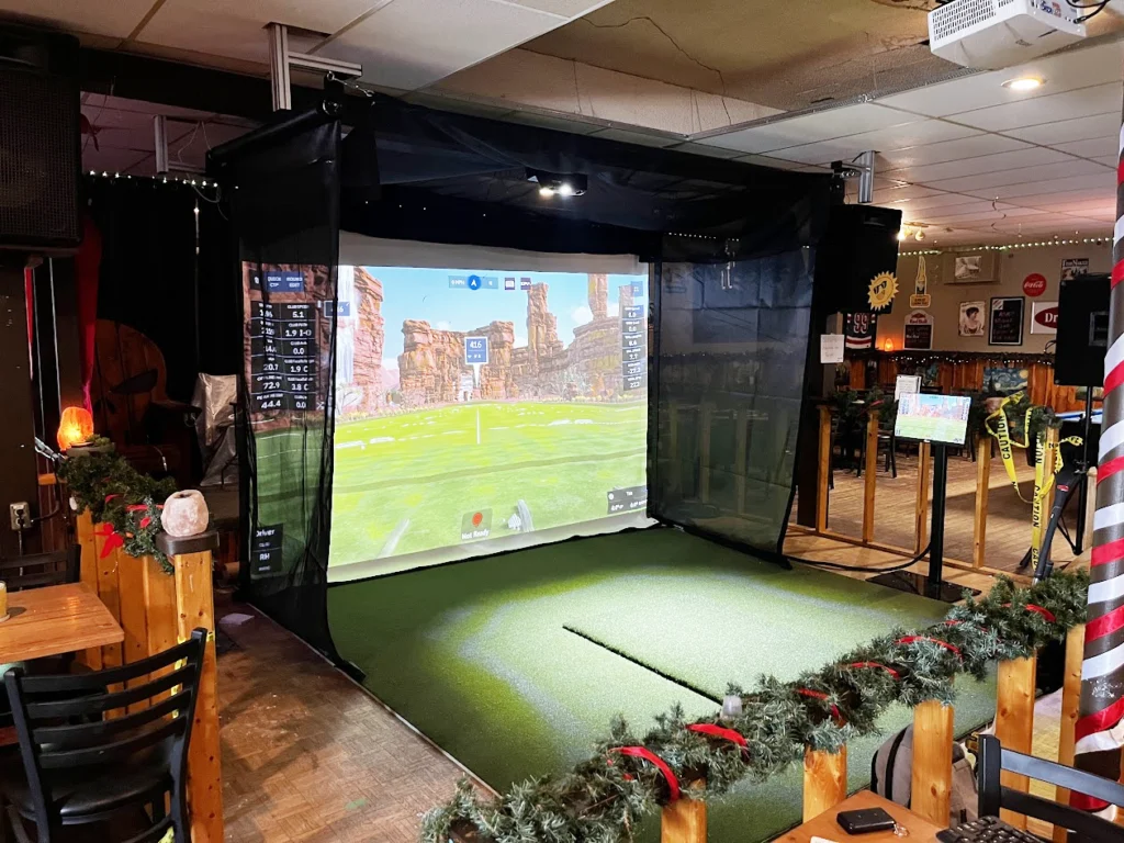 Vanish motorized retractable golf simulator enclosure installed at the Snow Lake Motor Inn in Snow Lake, Manitoba